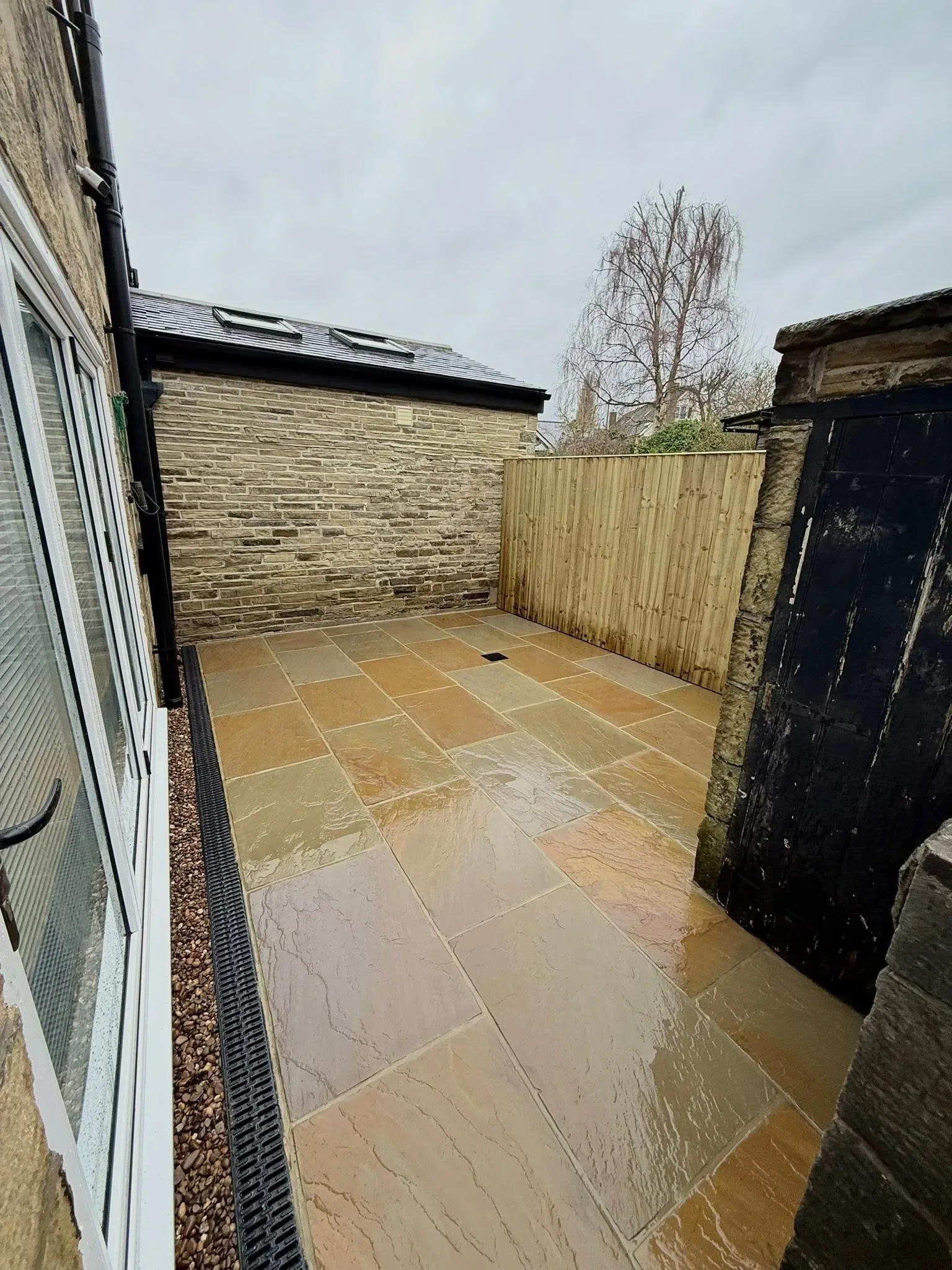 Finished paved rear yard with new drainage and fencing